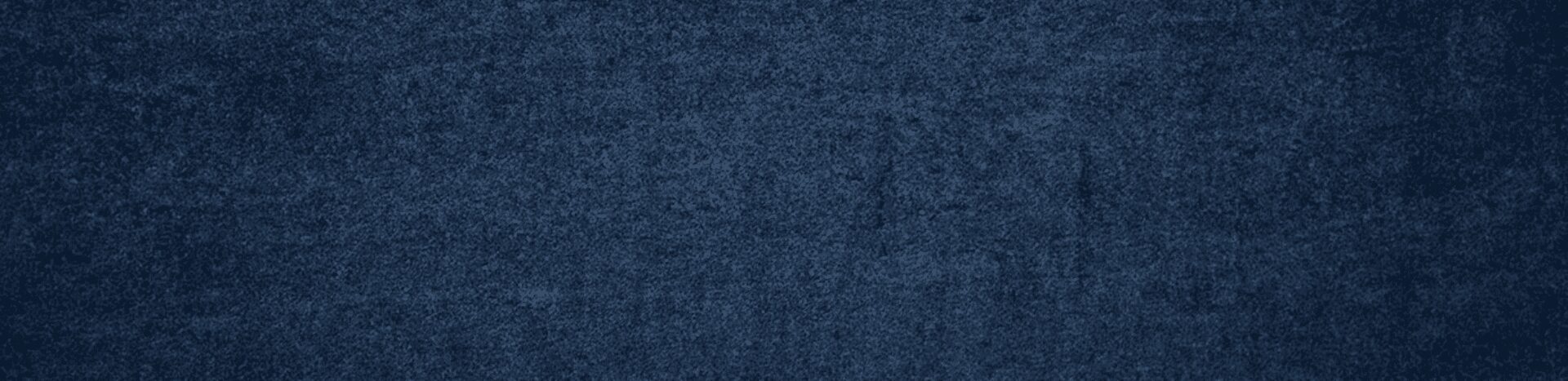 Close-up of dark blue denim fabric texture.