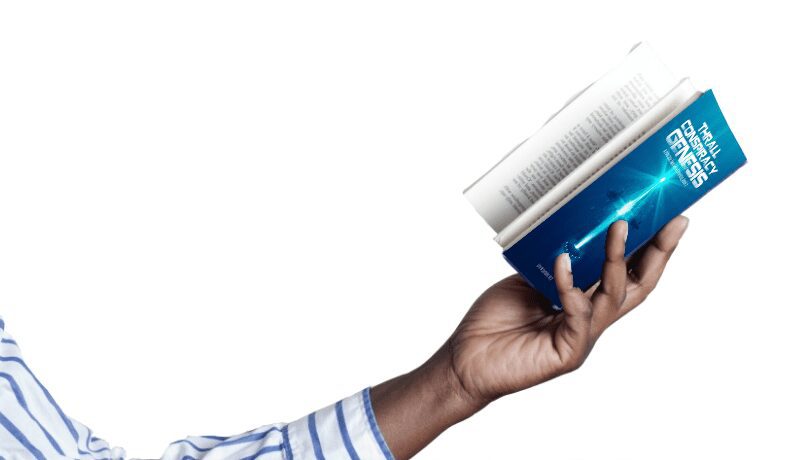 Hand holding a small blue book with a rolled newspaper.