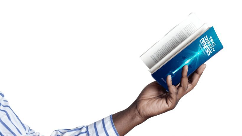 Hand holding a small blue book with a rolled newspaper.