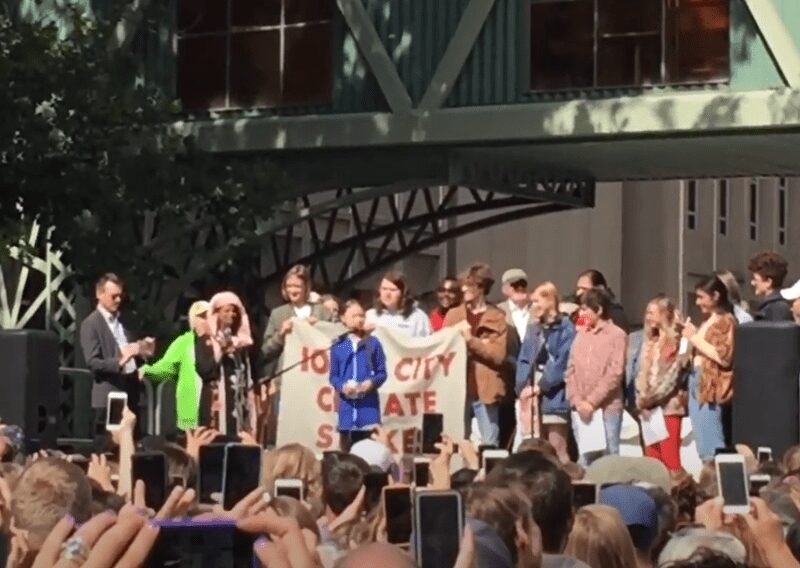 Group at a public event holding a sign promoting No Climate Hate.