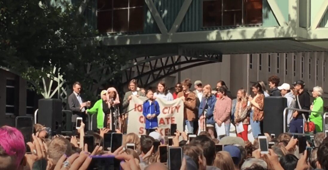 Group at a public event holding a sign promoting No Climate Hate.